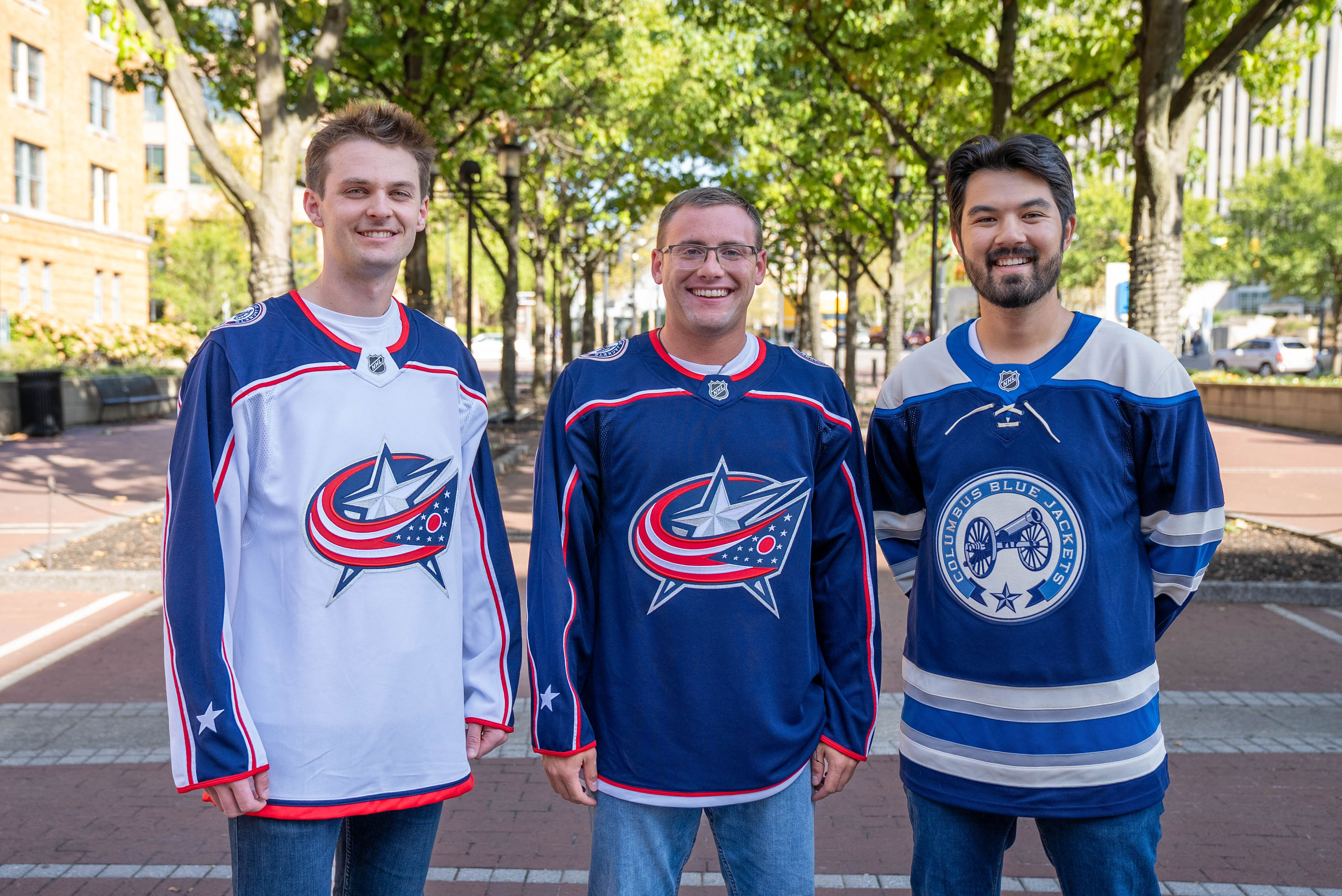 Three friends wearing Columbus Blue Jacket Jerseys
