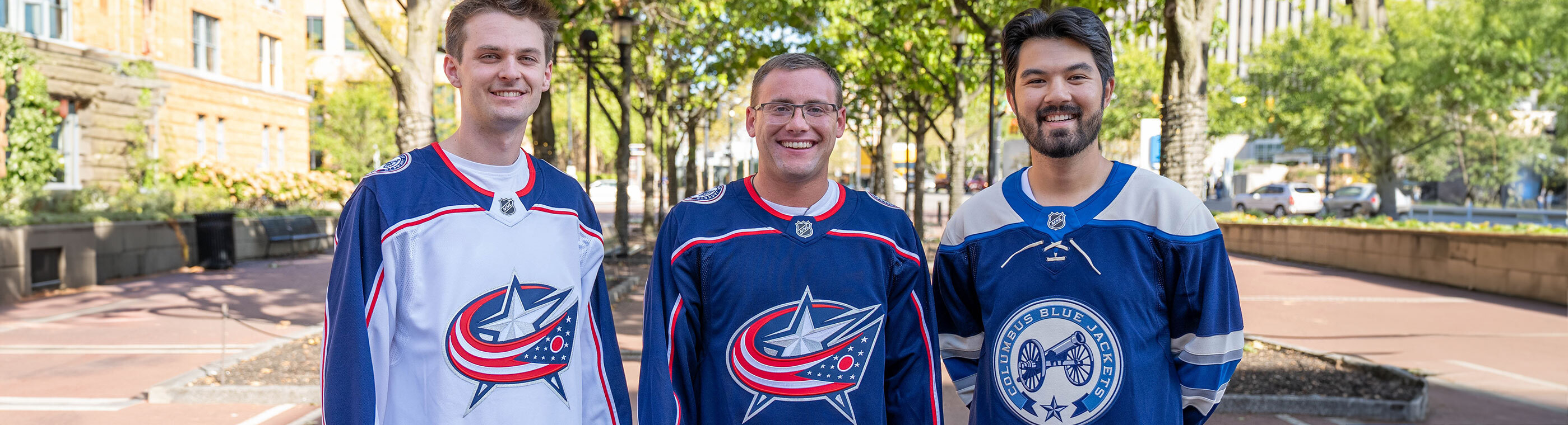 Three friends wearing Columbus Blue Jacket Jerseys