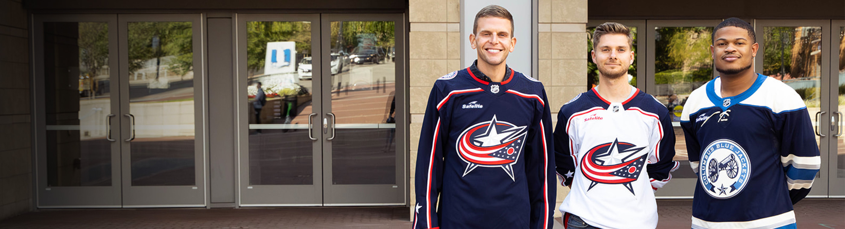 Three friends wearing Columbus Blue Jacket Jerseys