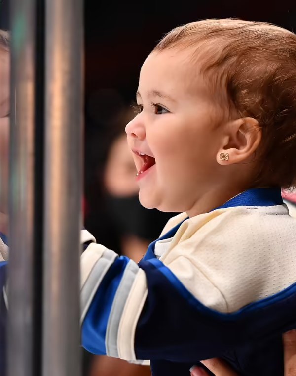 Baby smiling while wearing Columbus Blue Jacket gear