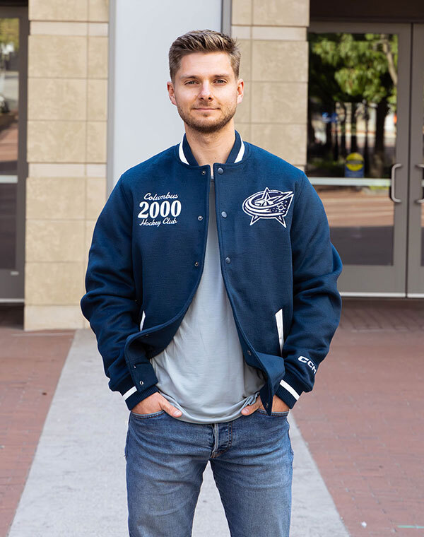 Man smiling while wearing Columbus Blue Jacket gear