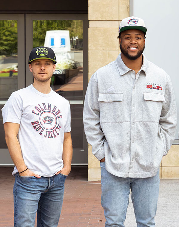 Men wearing Columbus Blue Jacket hat and other gear