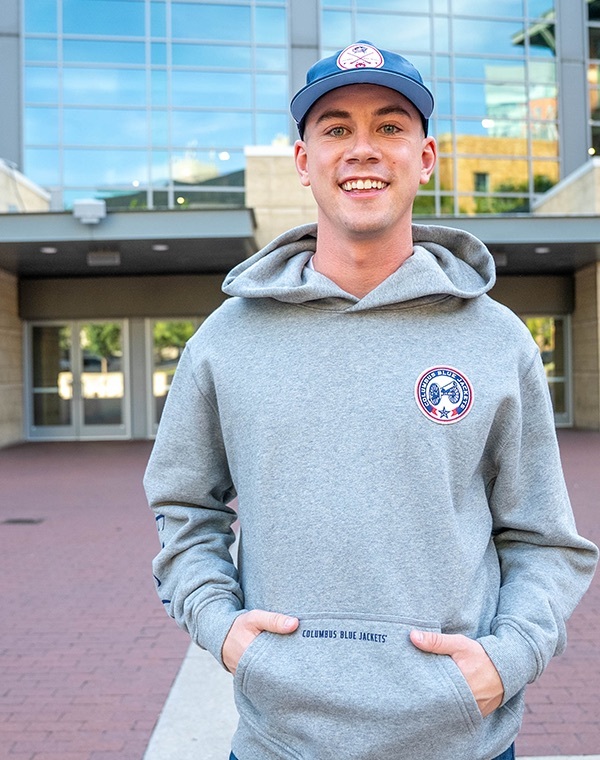Man smiling while wearing Columbus Blue Jacket gear