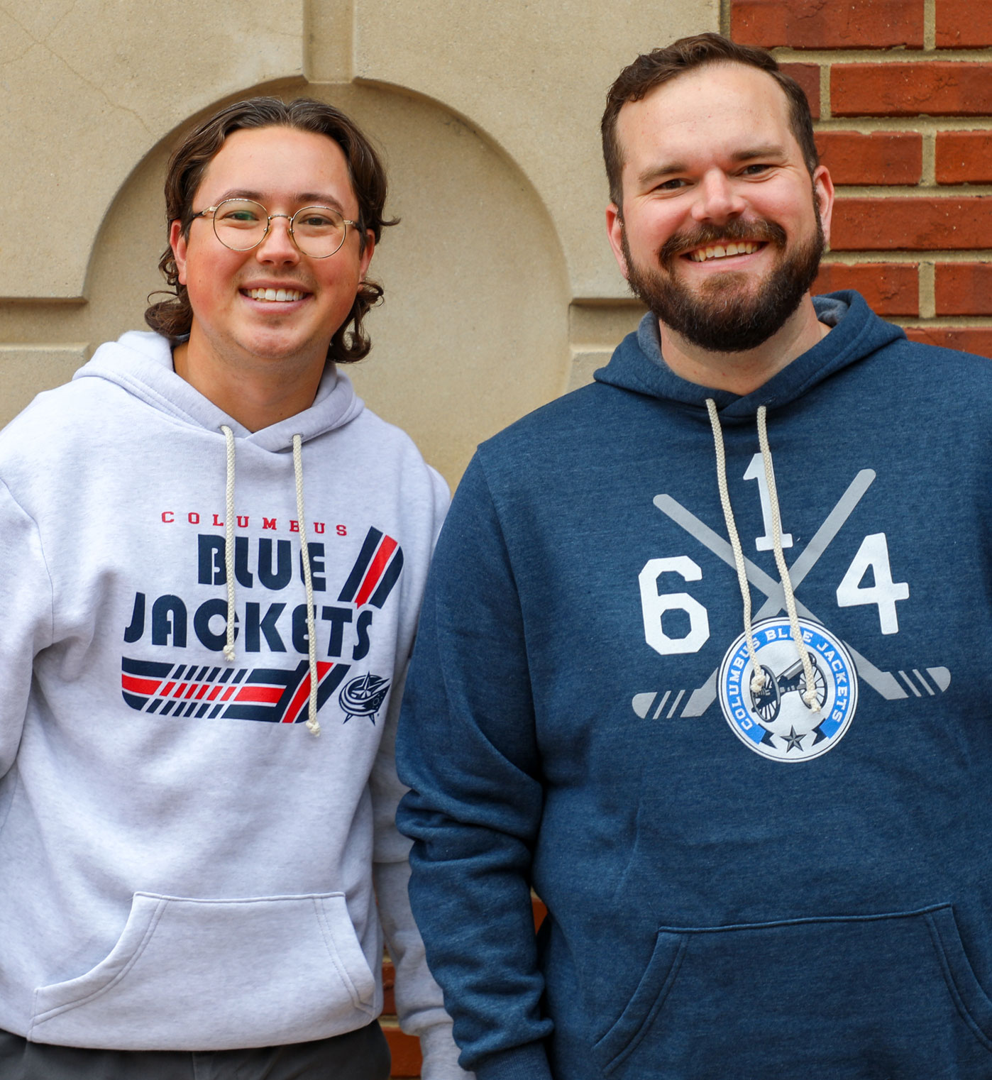 Two friends featured wearing Columbus Blue Jacket gear at store